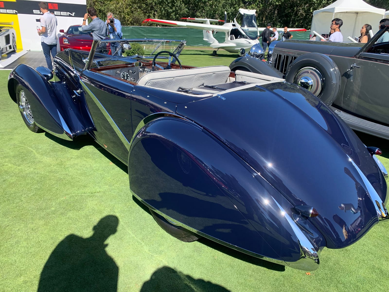 A concours field at dawn, lots under cover