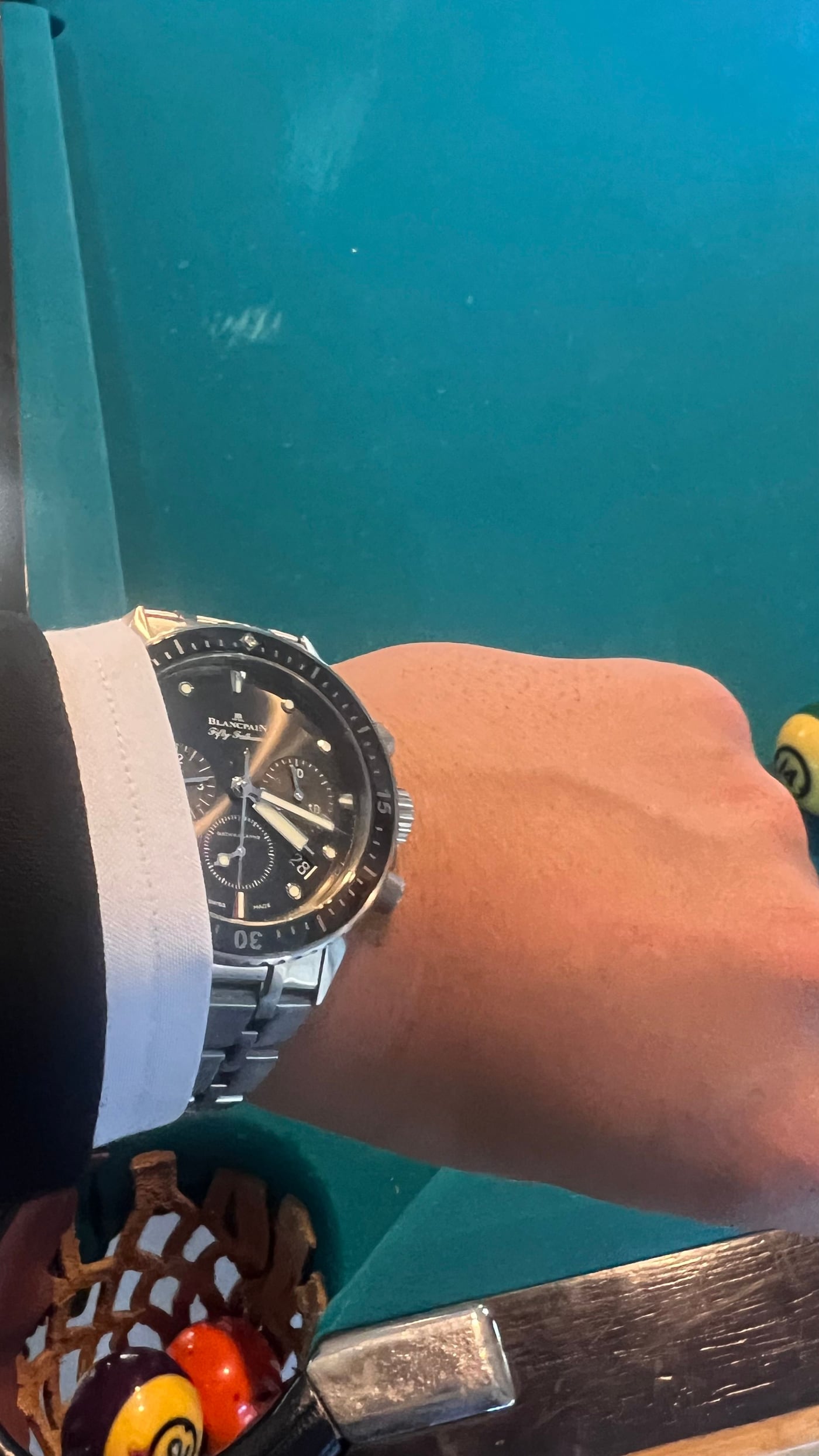 A Blancpain Fifty Fathoms on the wrist, understatement worn lightly