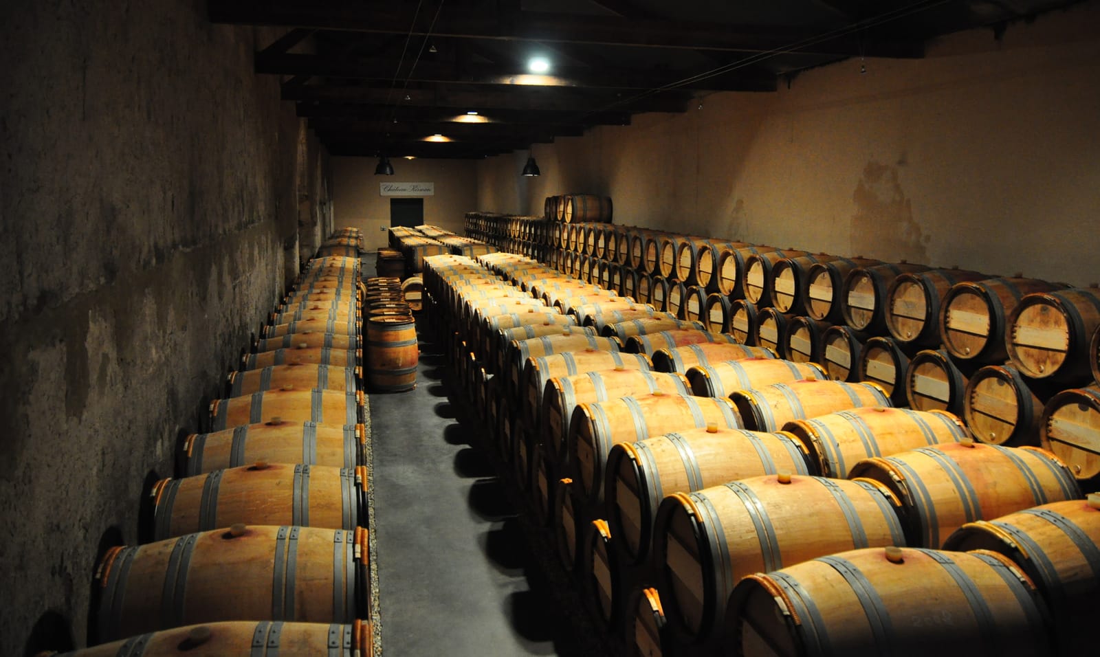 A dim cellar corridor, bottles resting on their sides